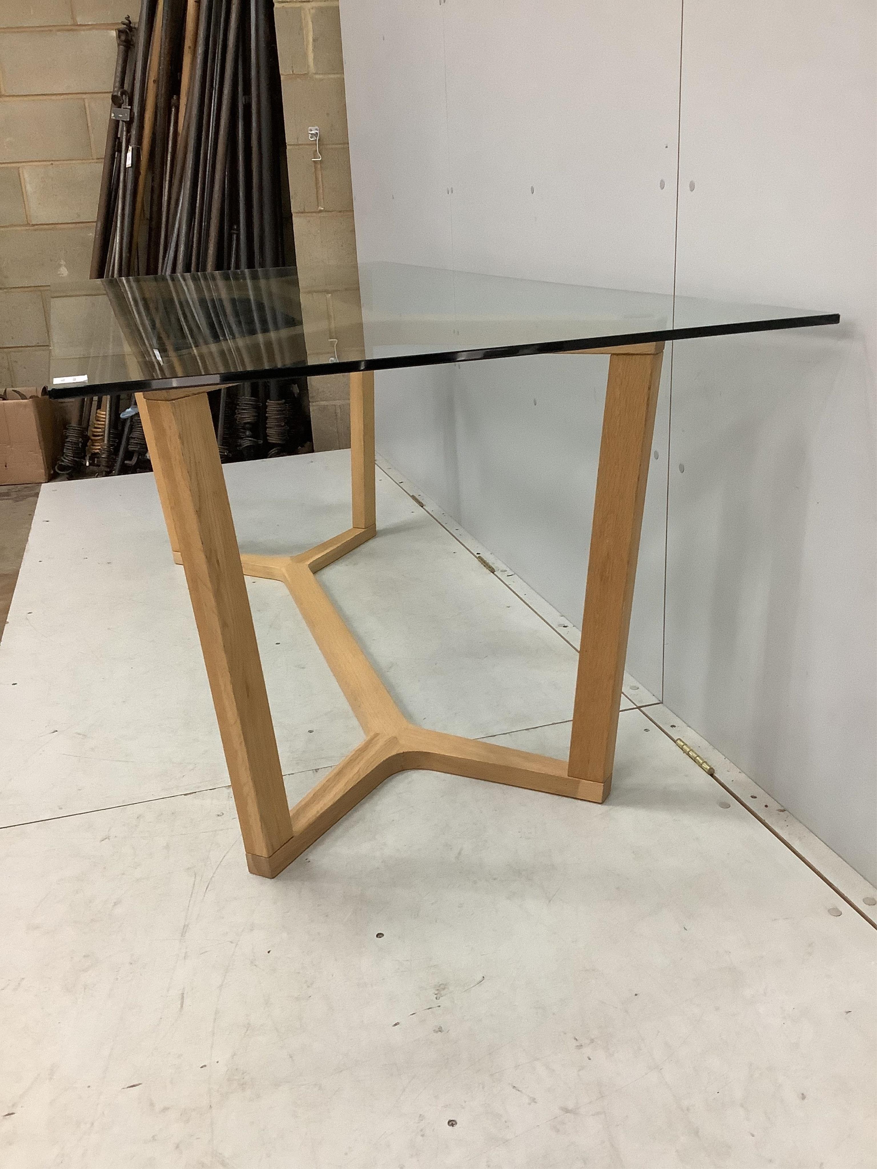 A Contemporary rectangular glass topped shaker style dining table on oak underframe, width 198cm, depth 89cm, height 72cm together with a matching bench seat